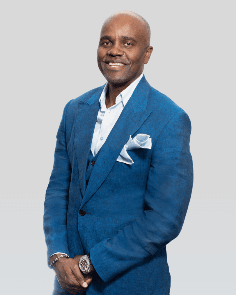 Wes Hall in a blue suit and smiling