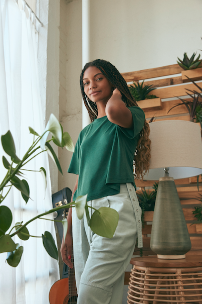 Photo of woman wearing green Allbirds tee shirt