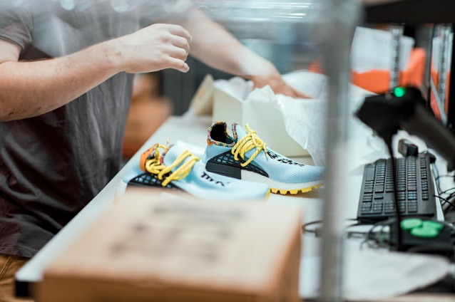 StockX Data Processing centre with Nike sneakers on table and person handling it
