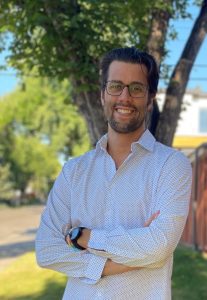 A white man in glasses, Chas Edgelow, CEO and Co-Founder of EverGen, stands with his arms crossed and smiles at the camera.
