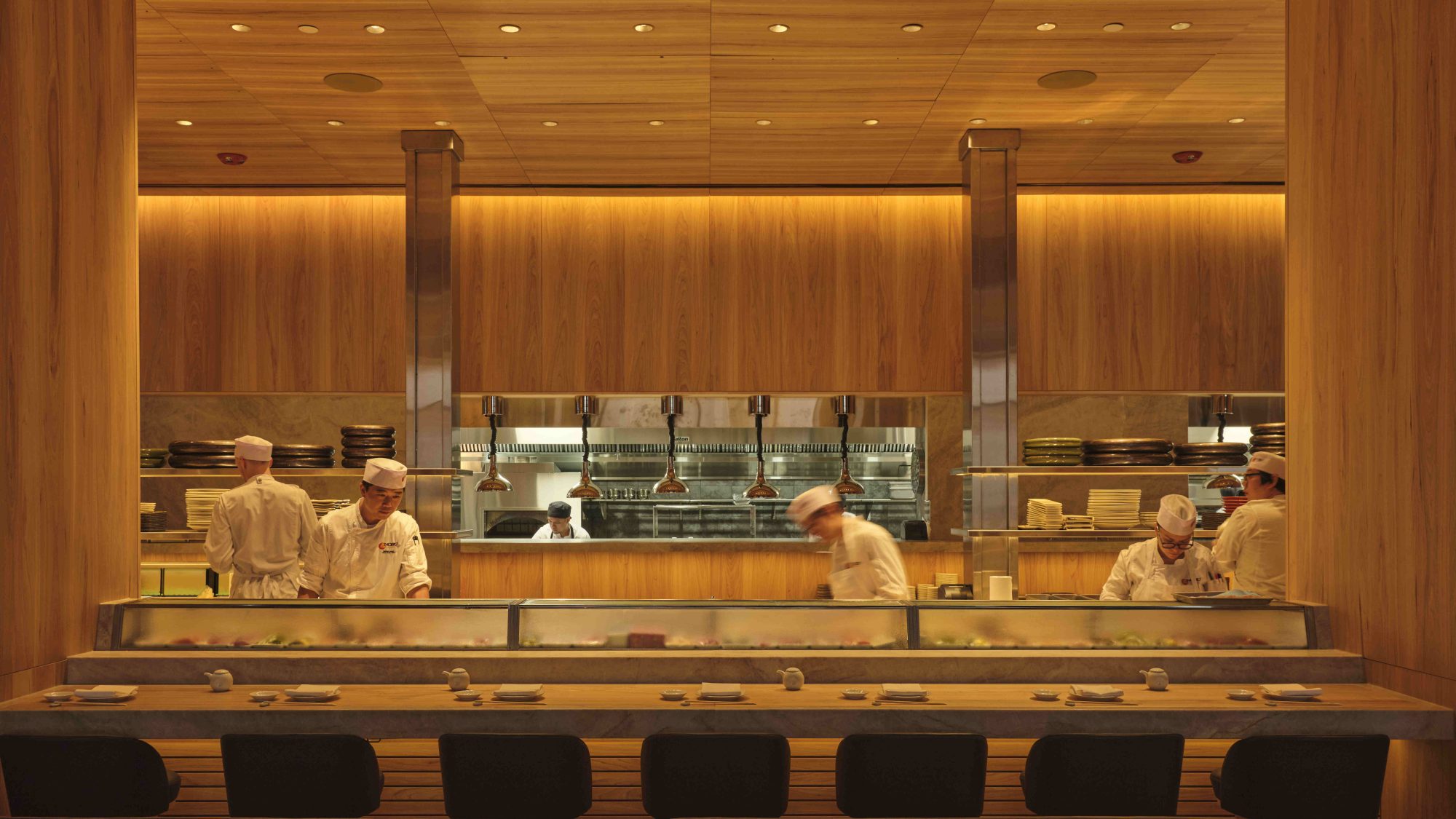 Sushi bar with chefs working behind it