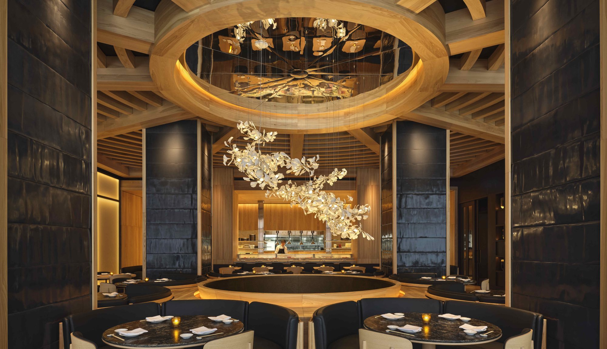 Restaurant shot of a grand dining room with a hanging chandelier.
