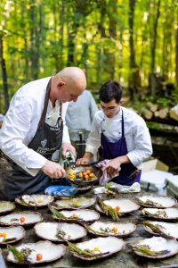 Chef Michael Statlander prepares food alongside his team.