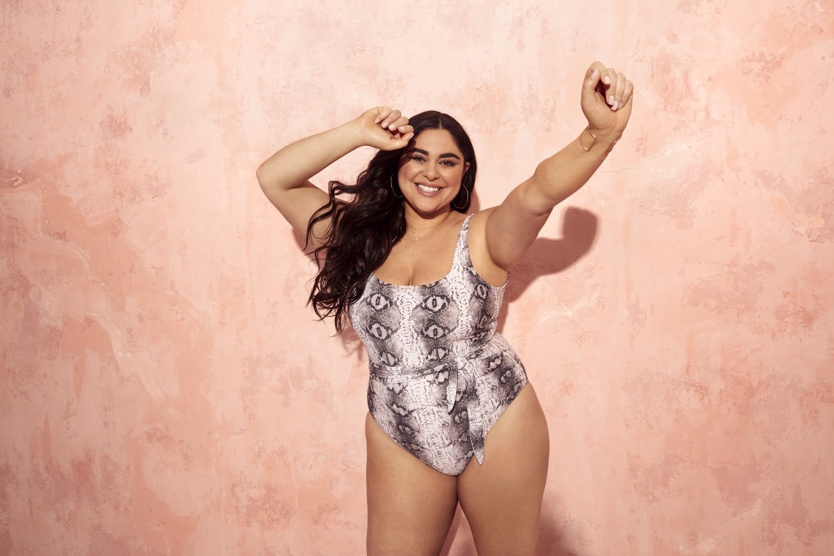 Roxy Earle poses in front of a pink wall wearing a snake print bikini from her Joe Fresh collection.
