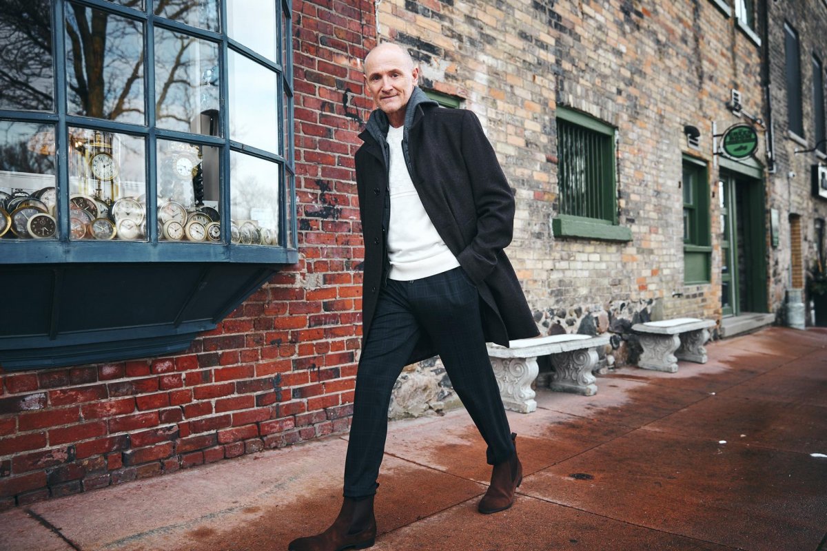Actor Colm Feore walking down street 