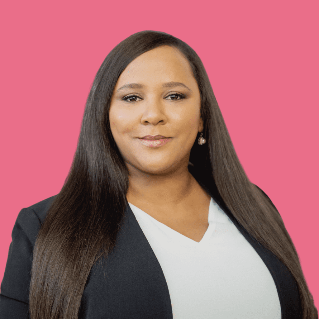Meryl Afrika in black blazer and white blouse on pink background