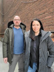 Tomas Ronis and Erin Chan, co-founders of Rhenti, stand outide in winter jackets and smile at the camera
