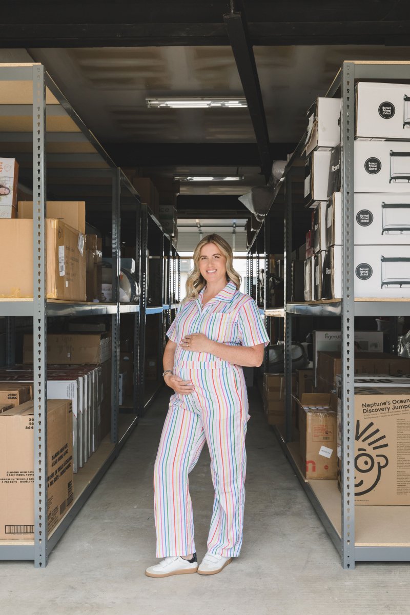 Woman in striped jumper holding pregnant belly