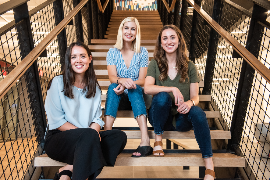 Group of three women sitting on staircase